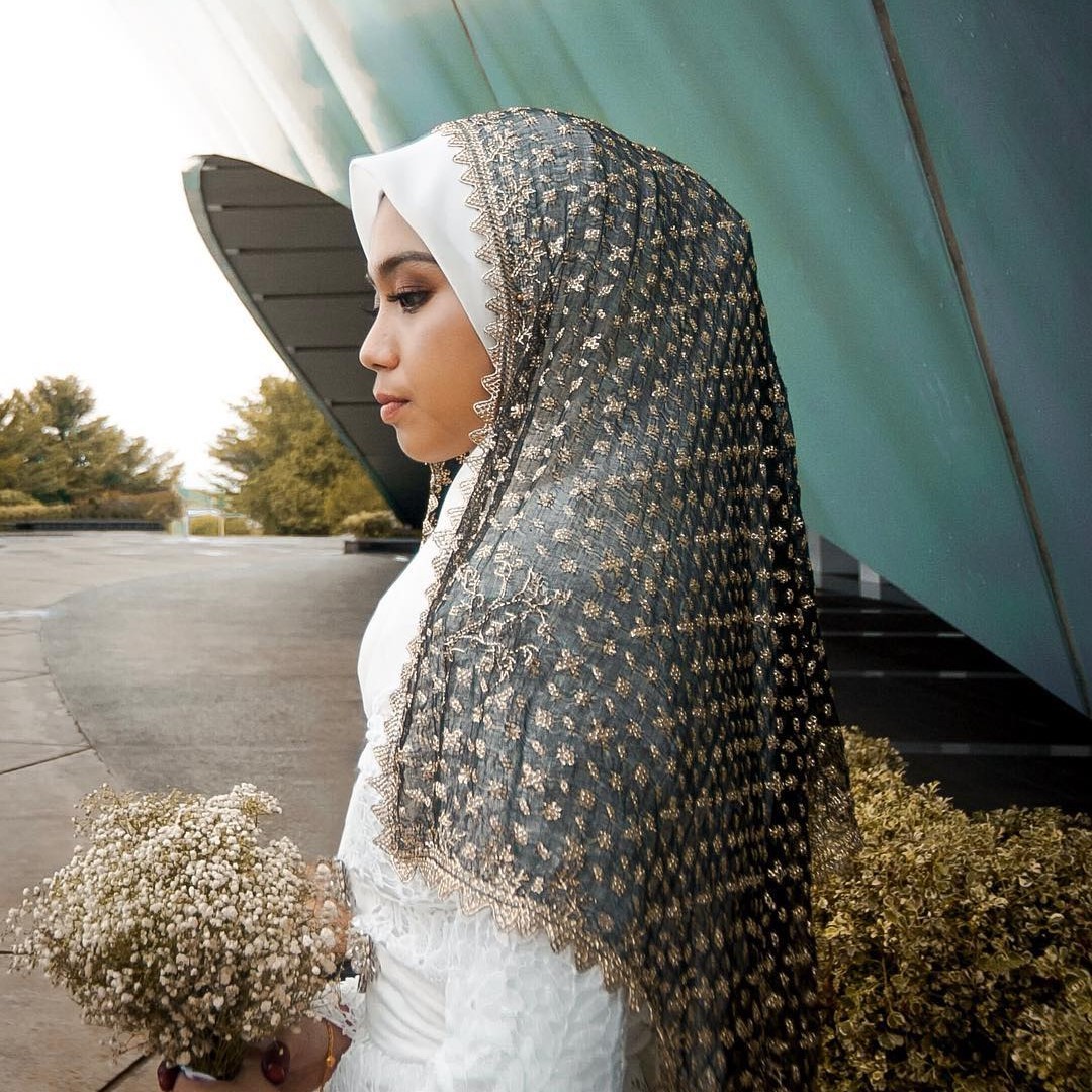 Women wear keringkam as part of their wedding veils.